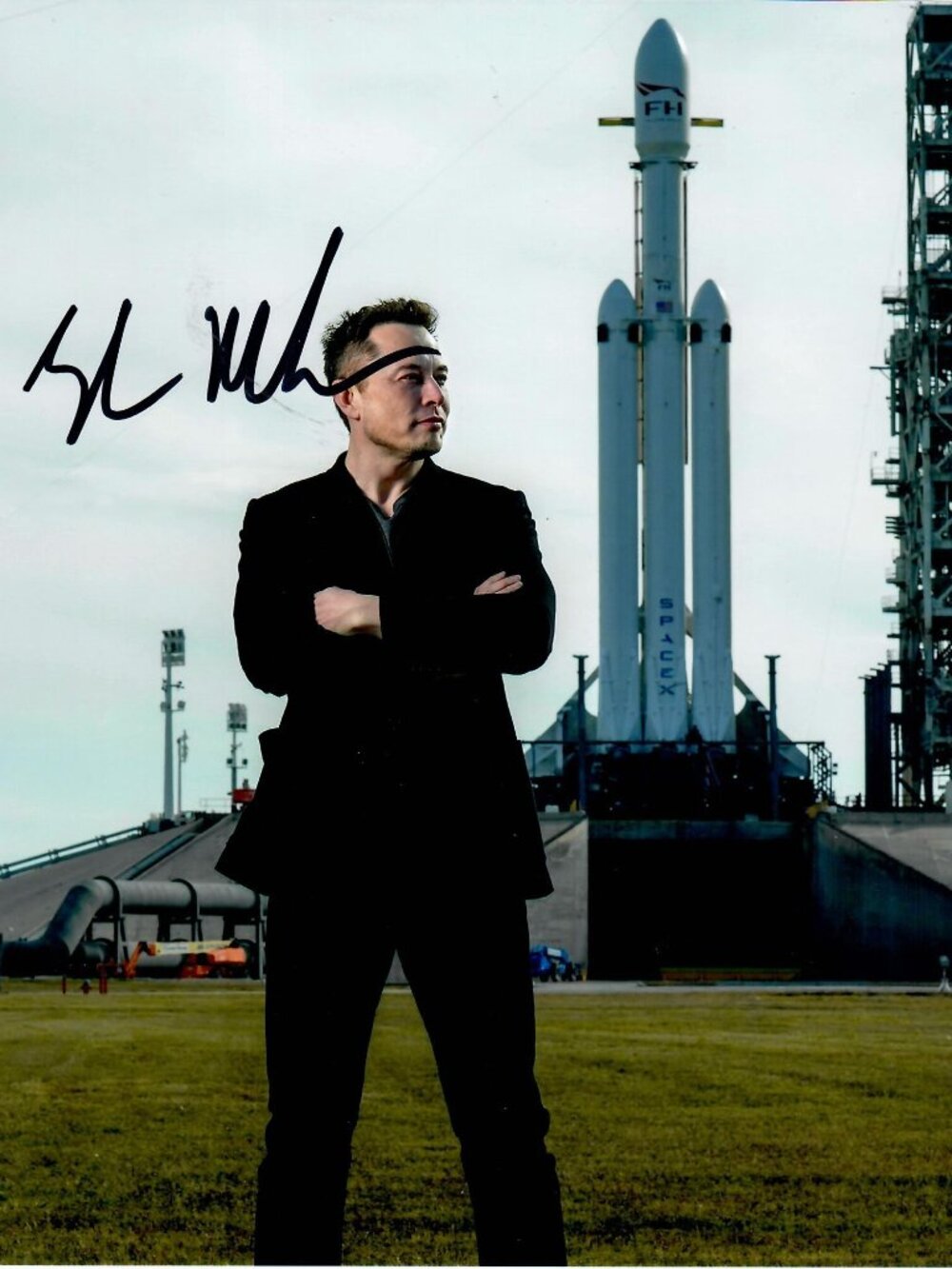 Elon Musk entrepreneur posing in front of a SpaceX Falcon Signed 8X10 Photo